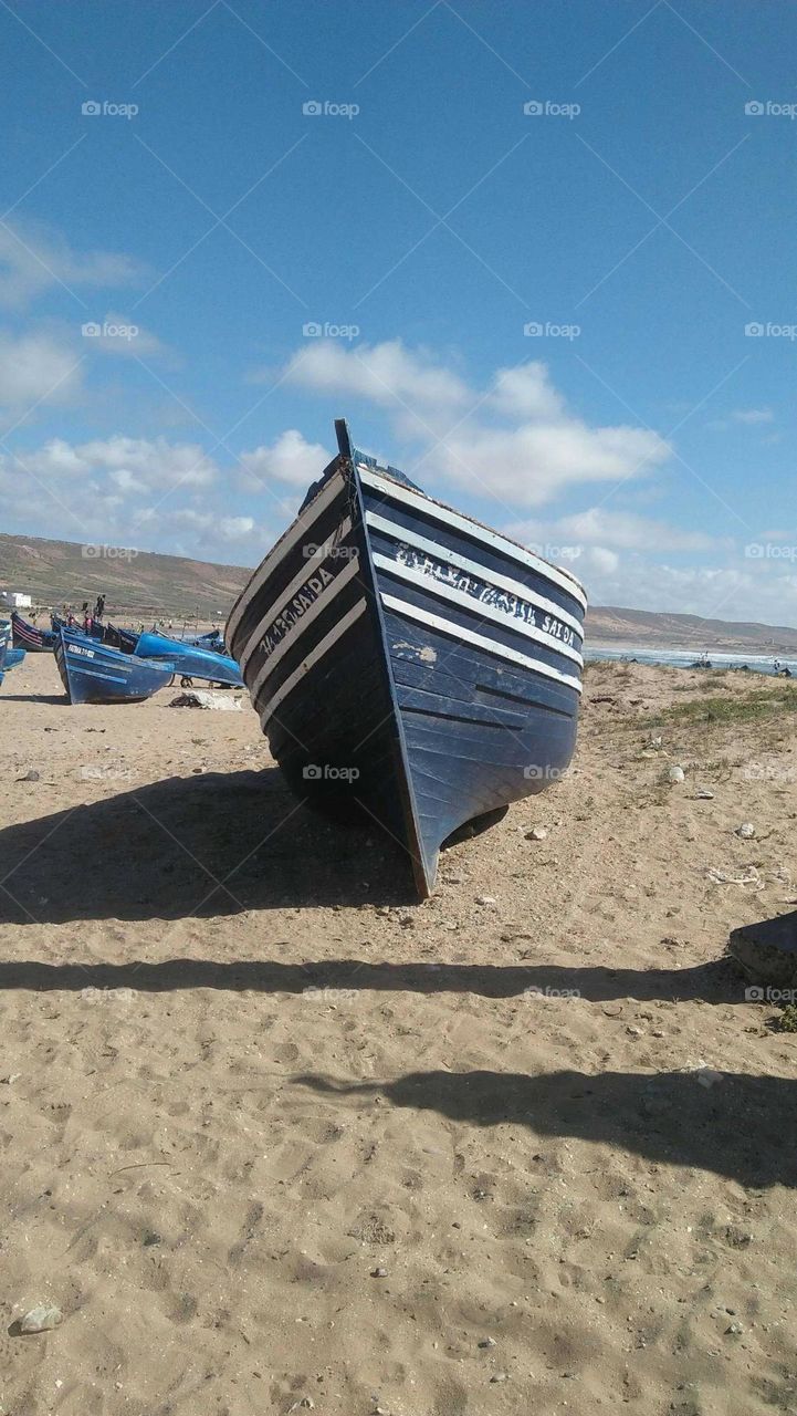 Beautiful boats on sand near the beach.