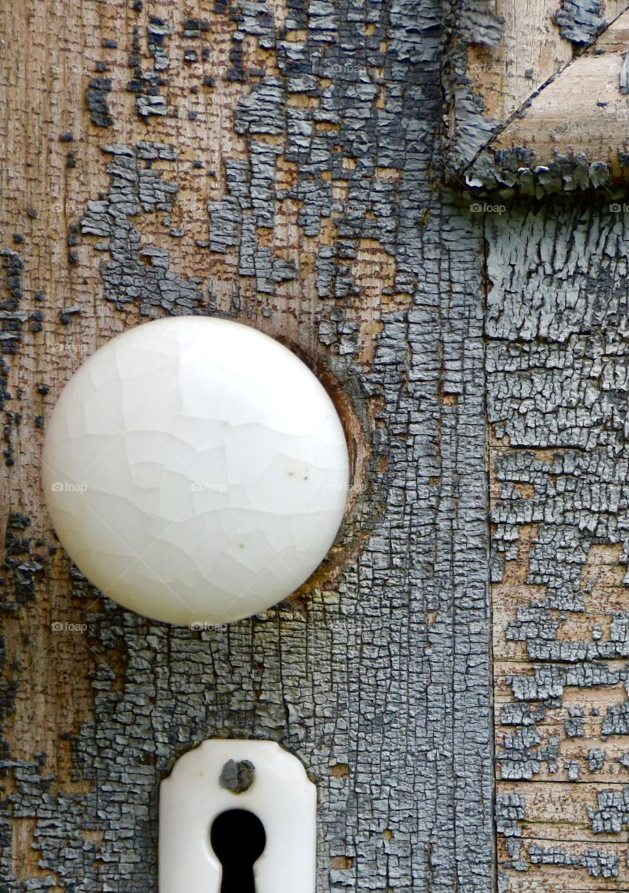 Circles, old door knob on an old worn door