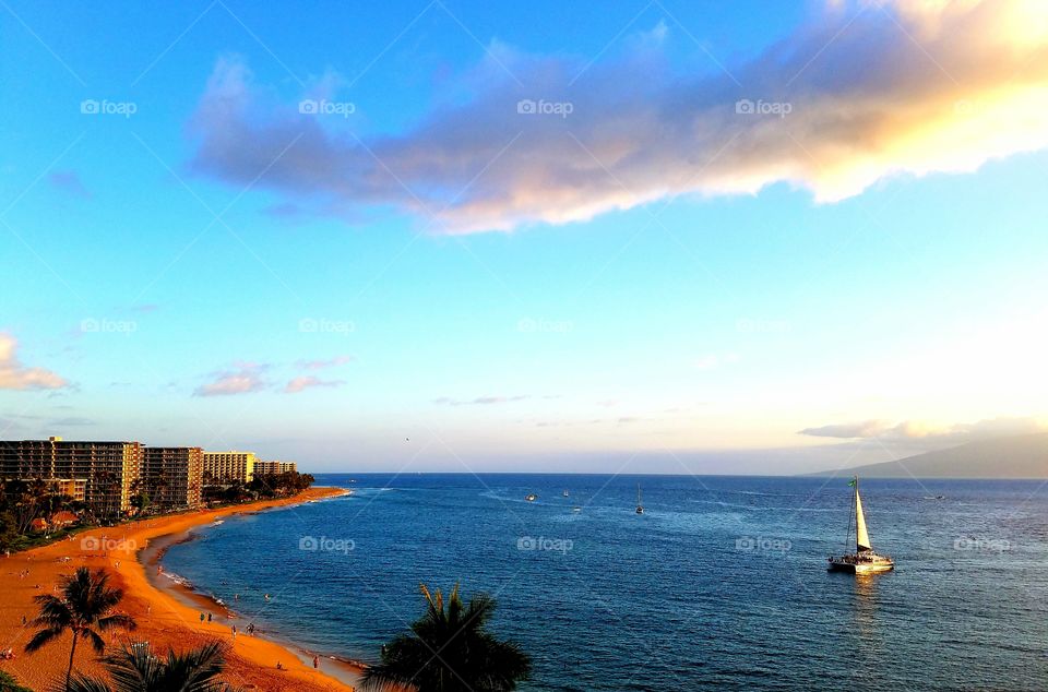 Sailboat on idyllic sea at sunset