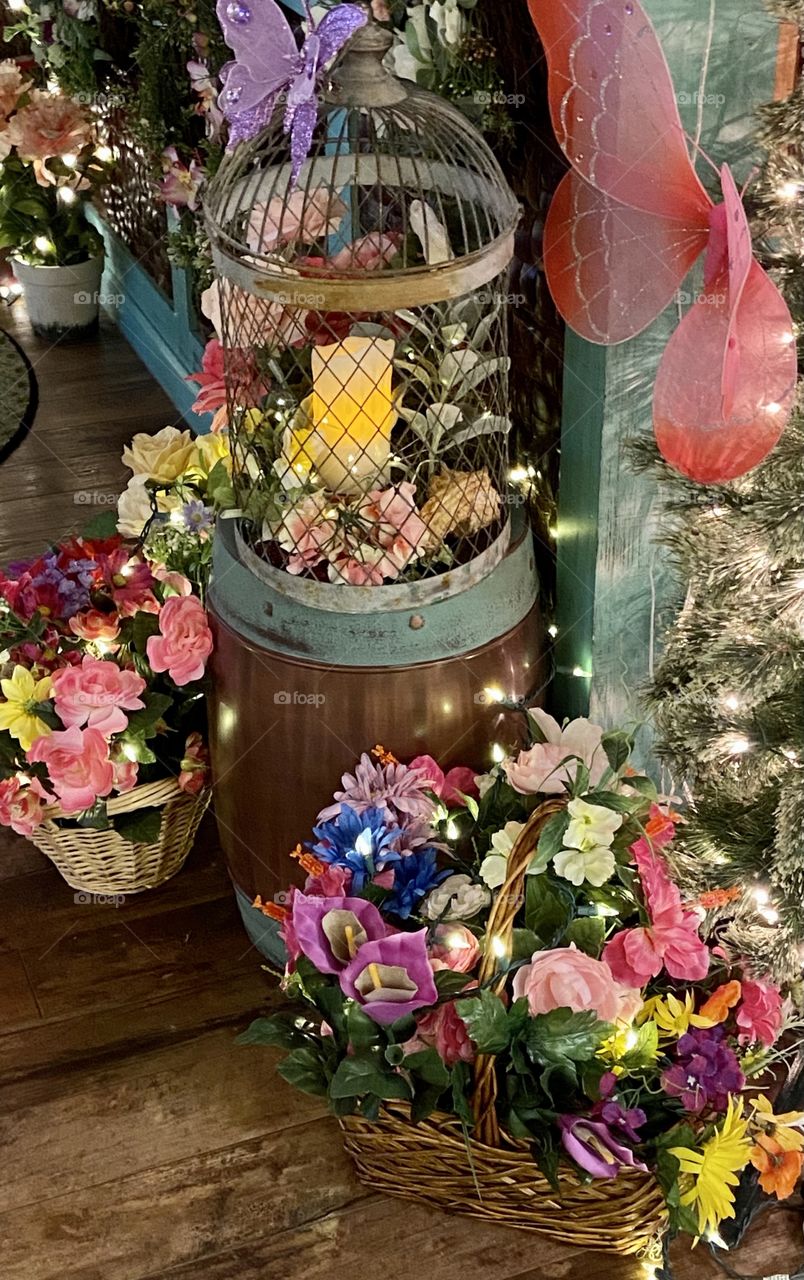 A beautiful magical display of colorful flowers with strings of lights intertwined