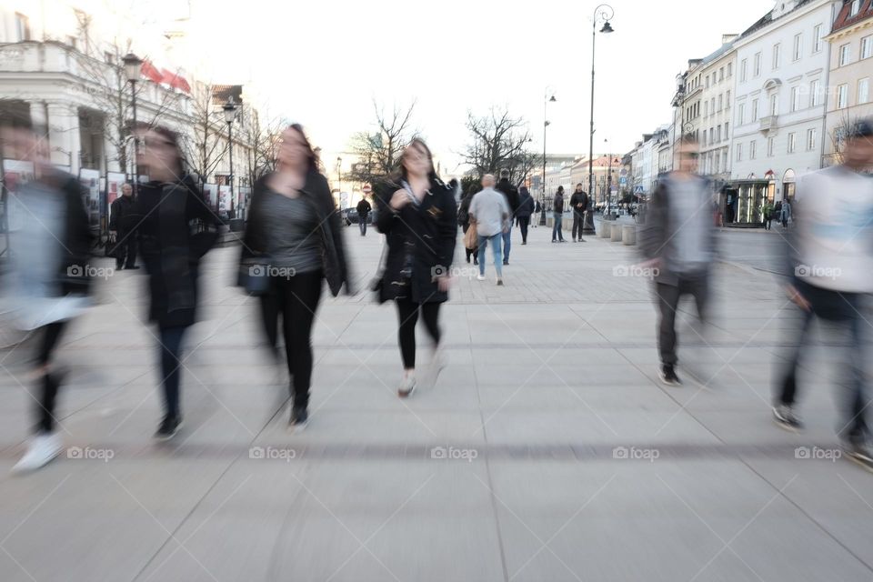 group of people walking along the main street