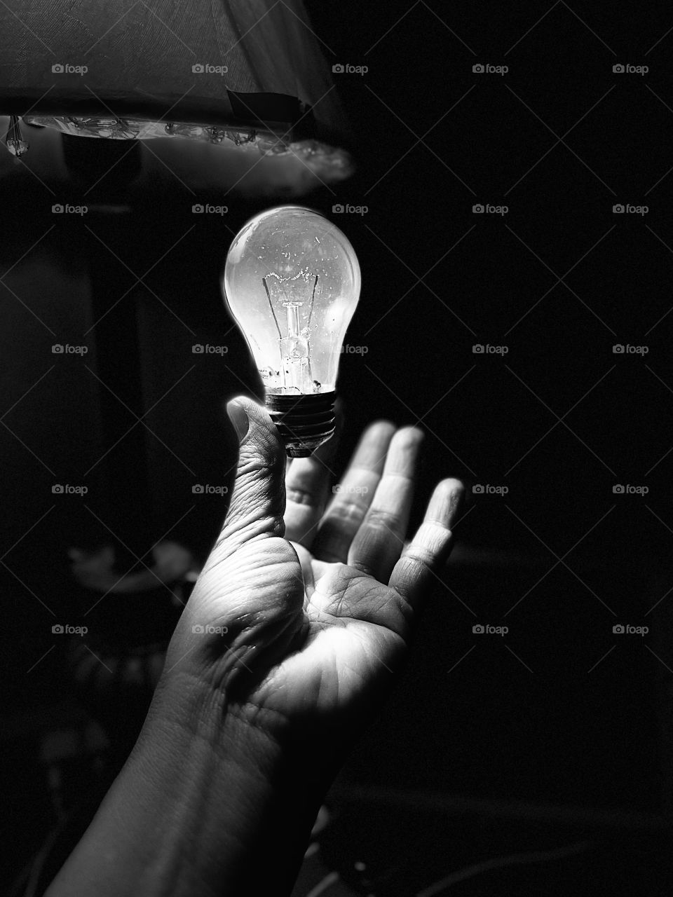The bulb on the hand with mono lighting 