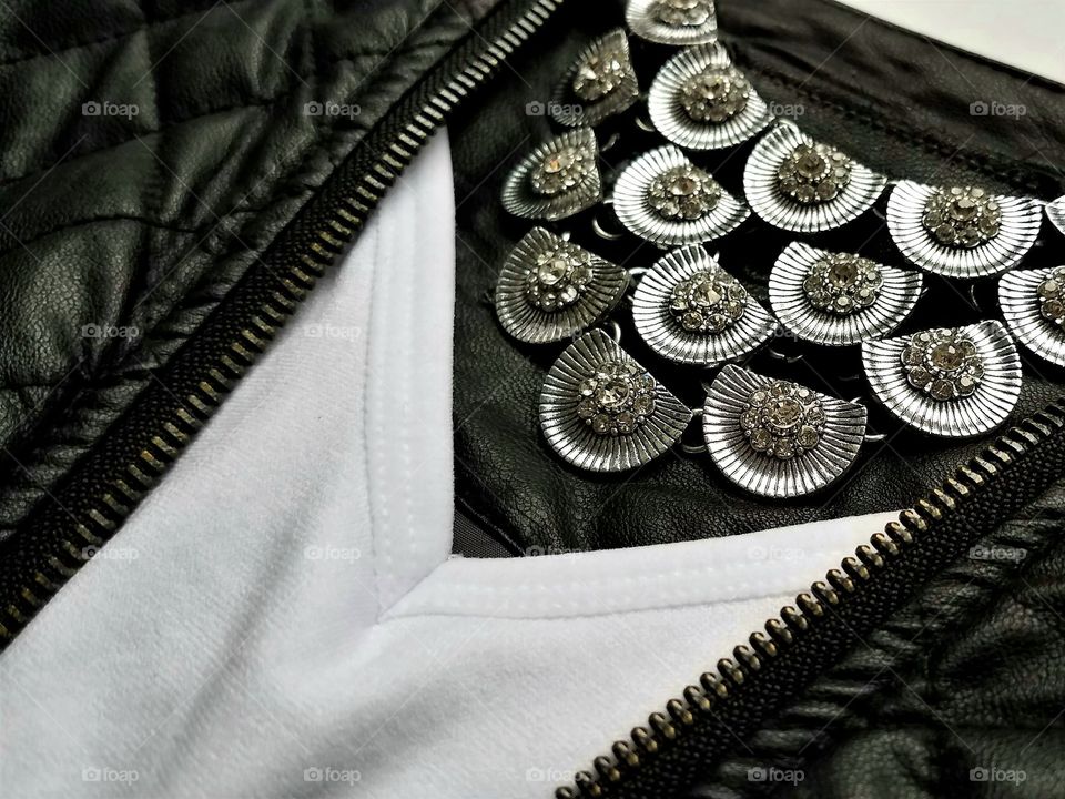 Antique jewelry on leather jacket
