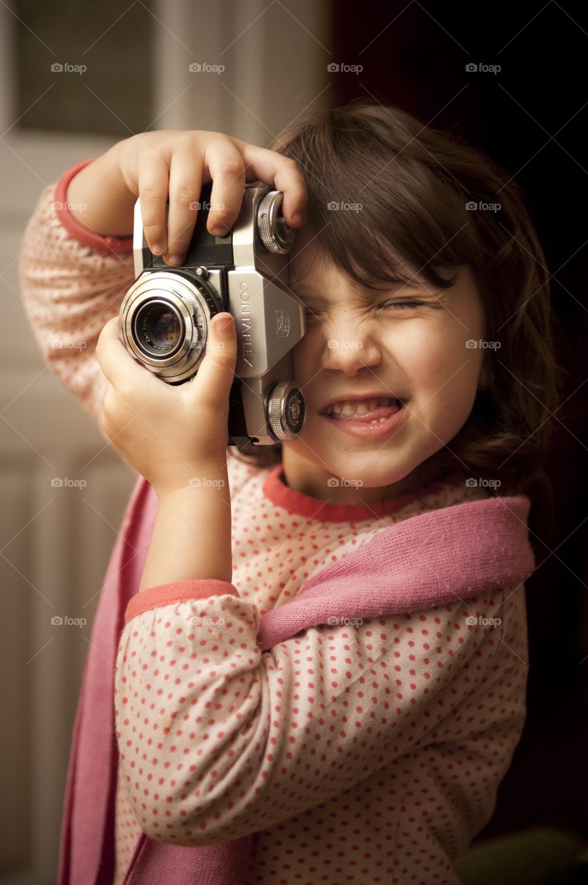 Cute girl taking photograph