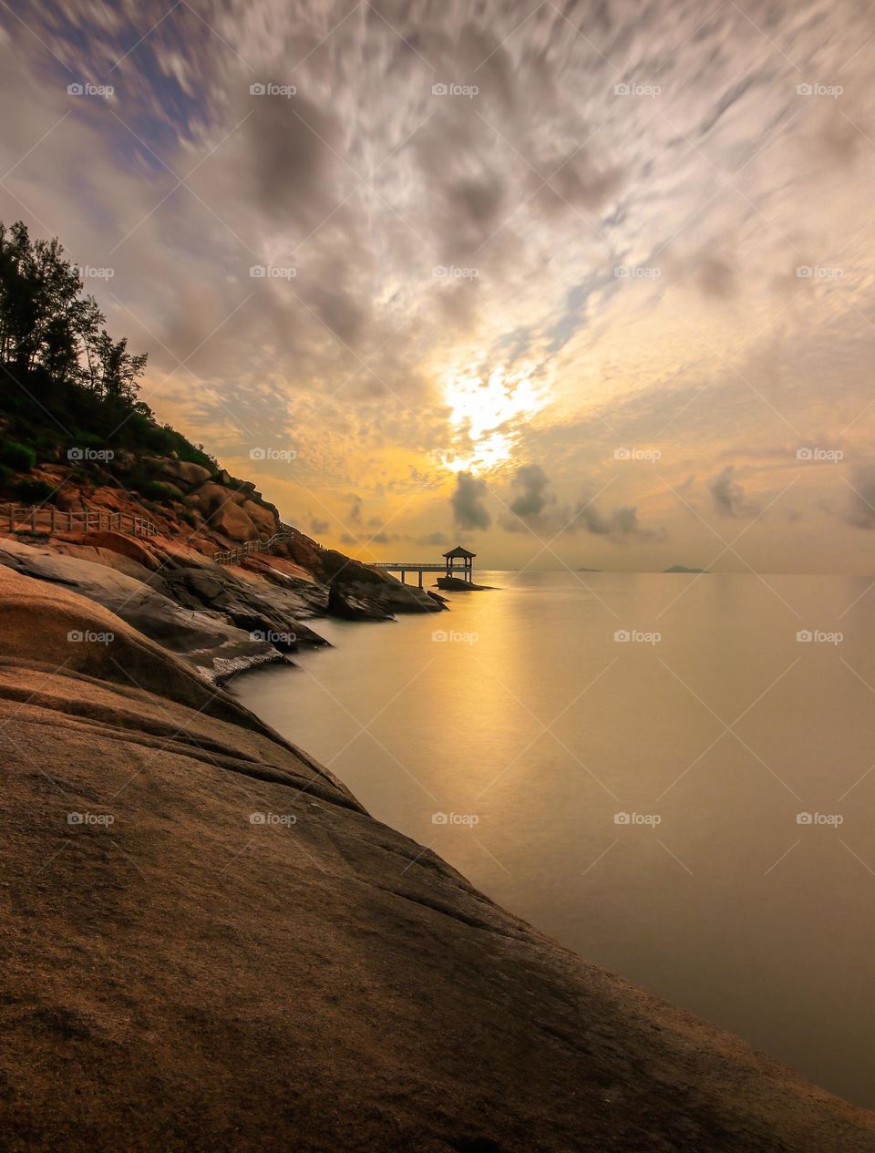 Sunrise dawn caught at the rocky beach side area.