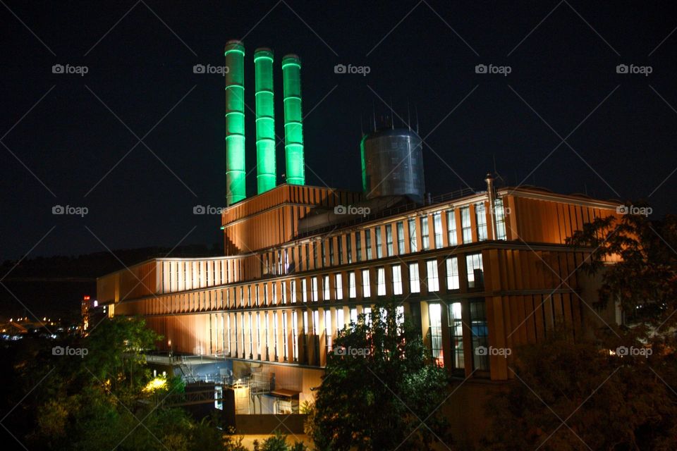 Illuminated heat and power station at night.