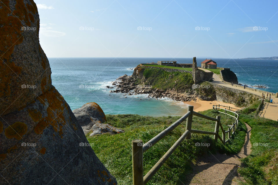 A Lanzada Peninsula contains among other tourist attractions a medieval tower and the Romanesque chapel of Our Lady of A Lanzada. Galicia, Spain.