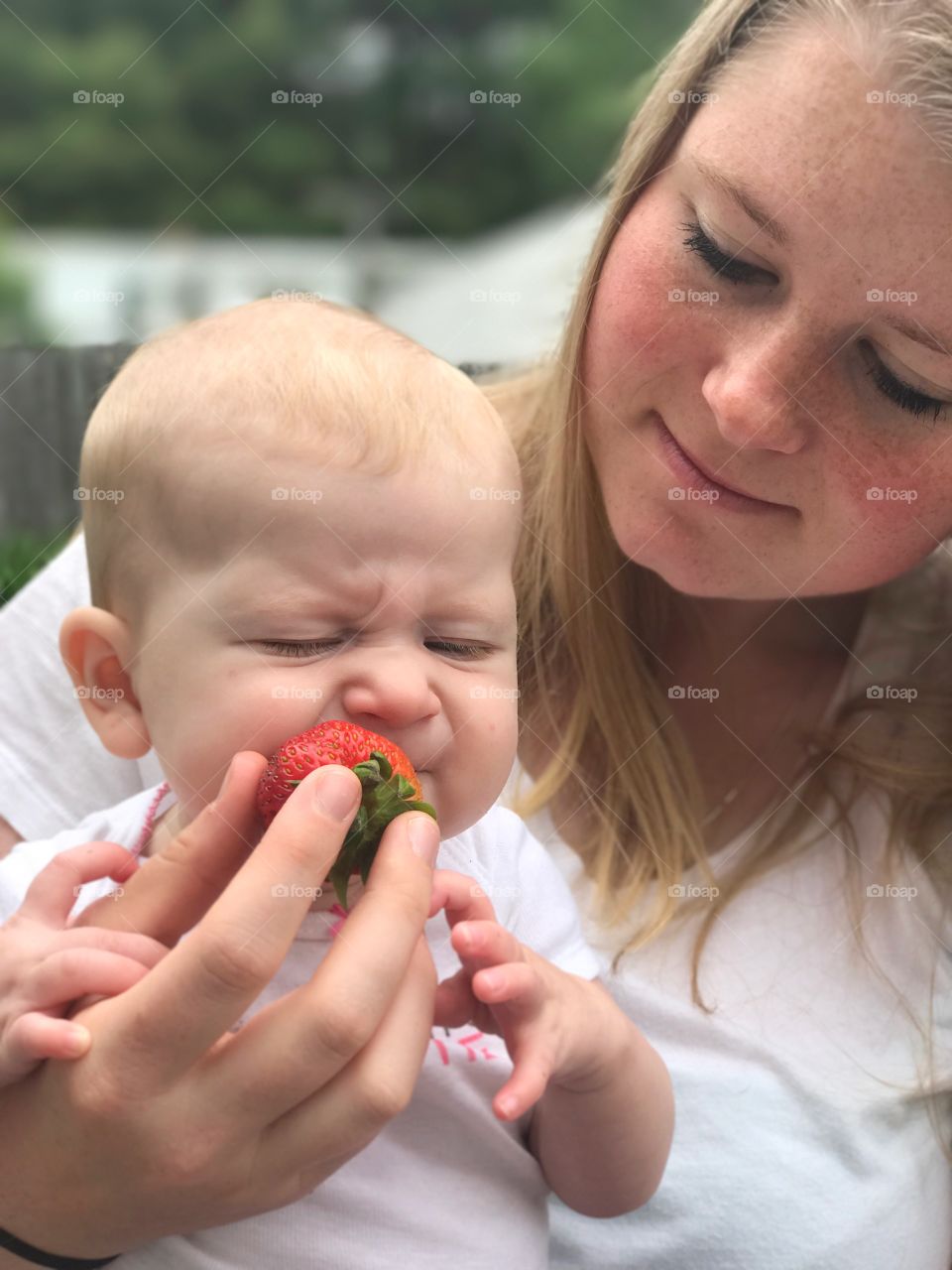 Trying a strawberry