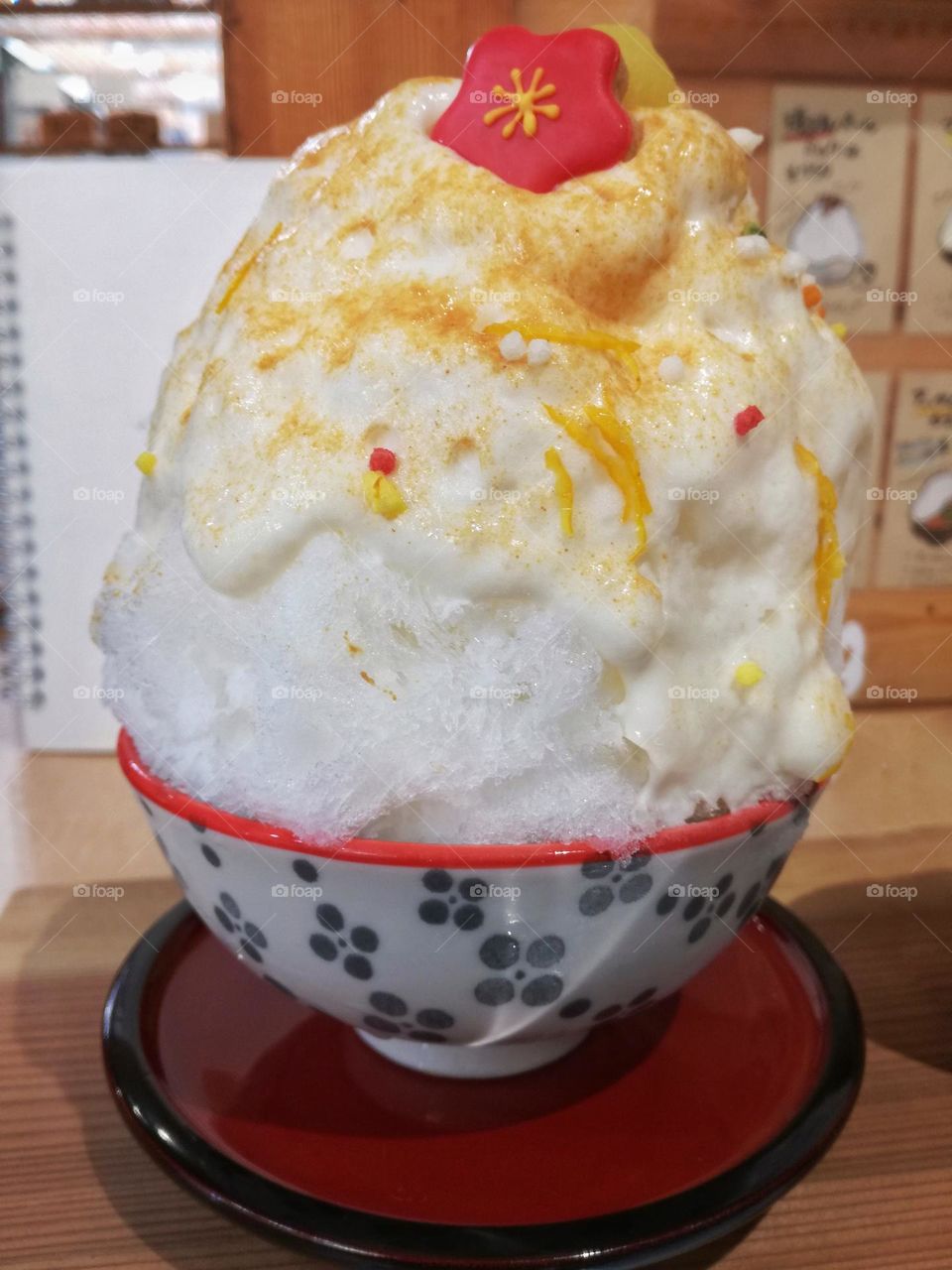 Cute shaved ice in Japan with a flower topping.