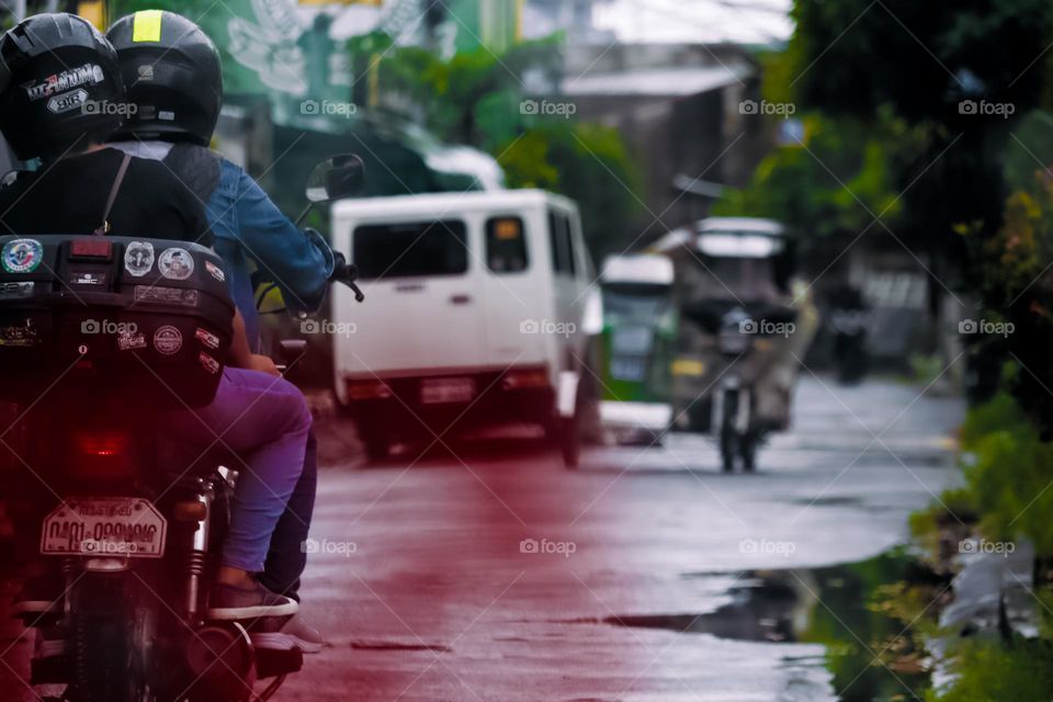 Two people in a motorcycle ride
 commute to work.
