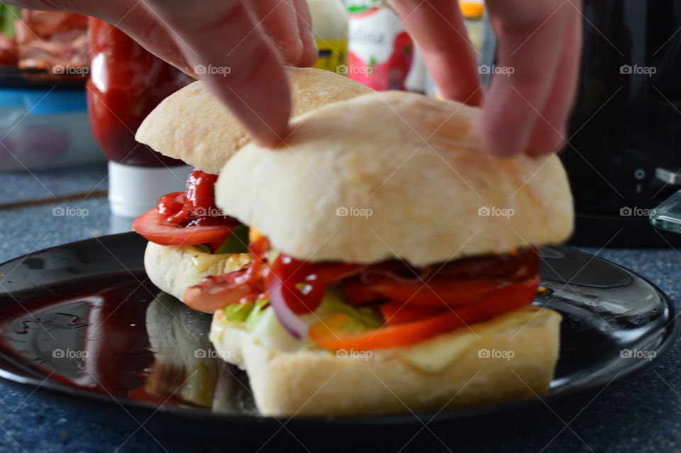 big delicious sandwitches with becon and fresh vegetables