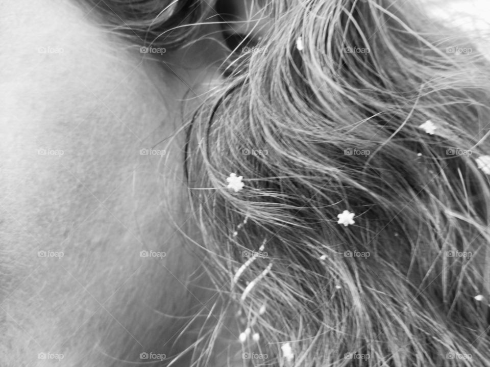 It’s not every day that you get to see the shapes of snowflakes. This picture captures a few in a woman’s wavy hair, complimented by her jewelry.