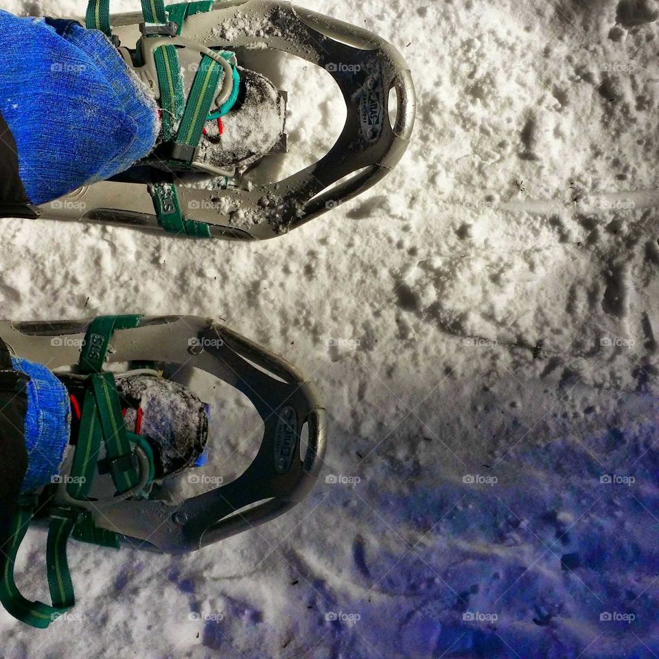 Close-up of a pair of snowshoes in the snow