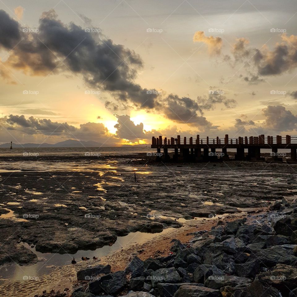 Low tide coast against sunset sky