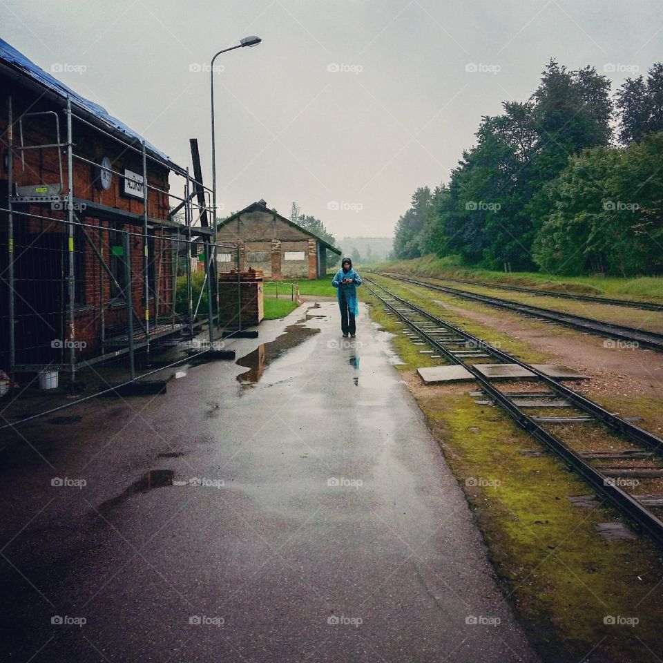 A photographer exploring narrow rails old functioning railway in Aluksne Latvia