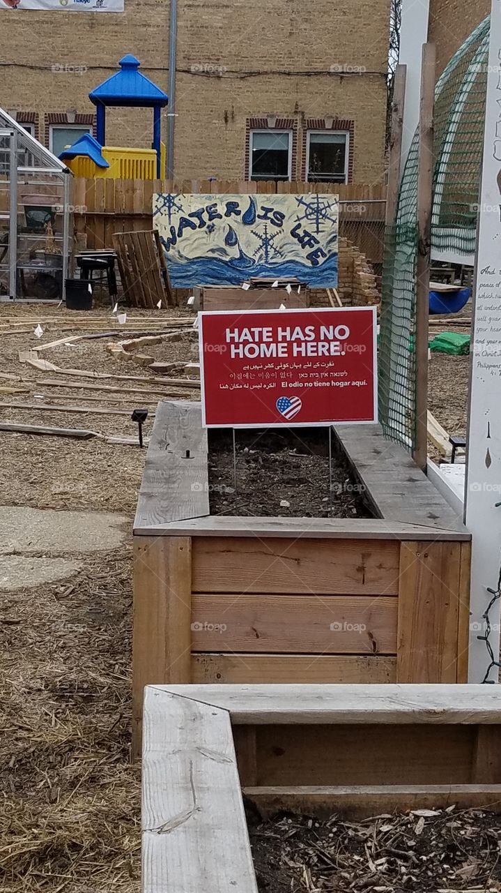 church garden, water is life sign, hate has no home here sign