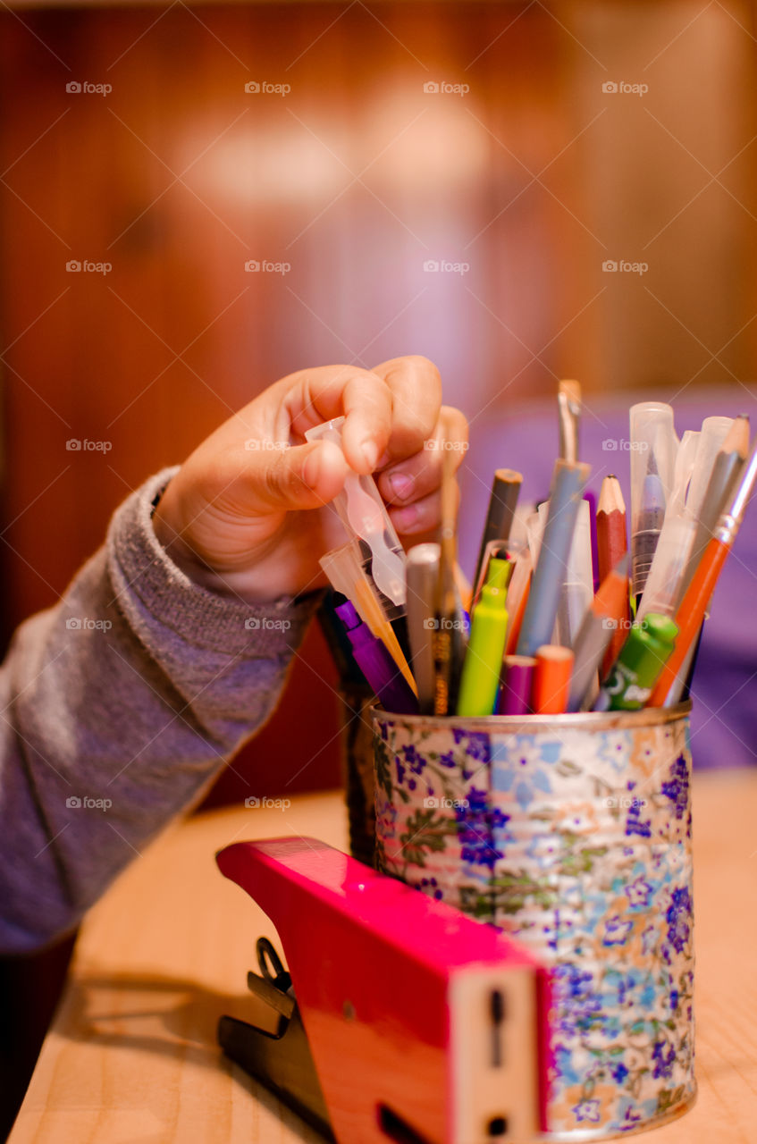 little boy looking for coloring pencil