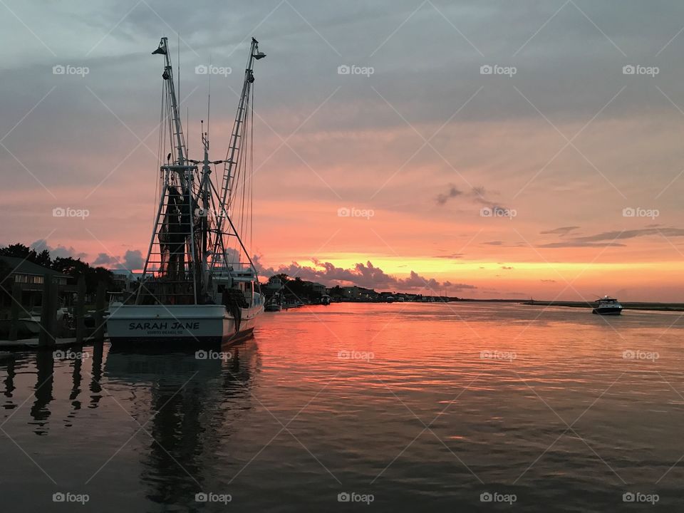 A shrimp boat at sunset.
