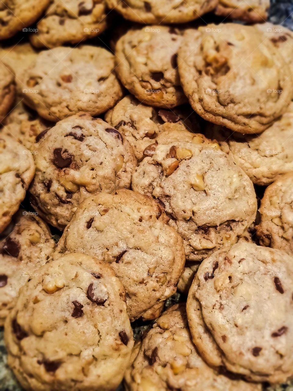 Delicious pile of chocolate chip pecan cookies fresh from the oven waiting for you to dive in and enjoy 