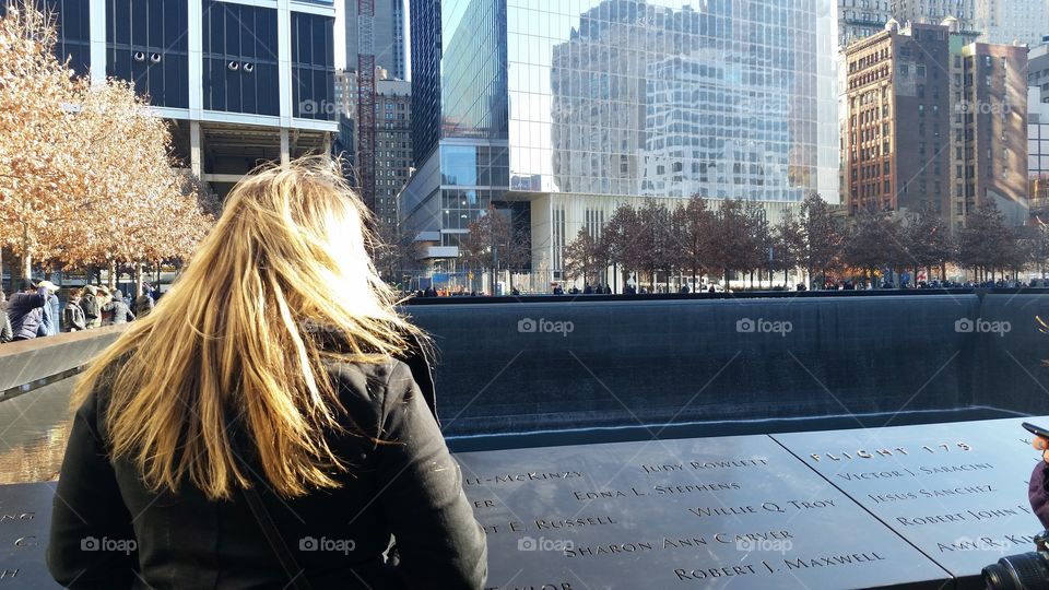 Girl overlooks the 9/11 memorial