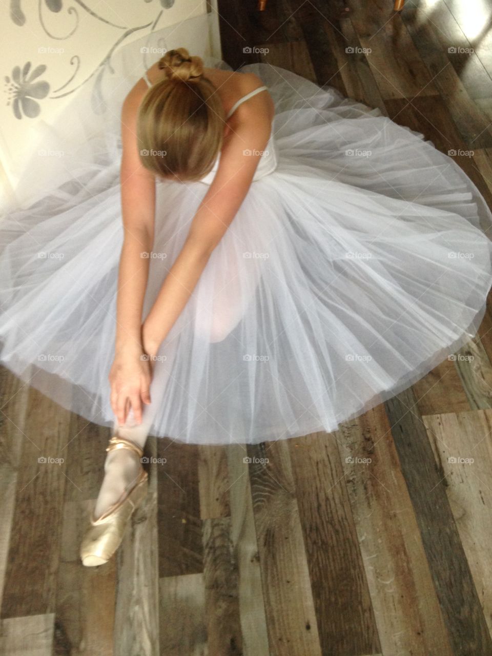 Ballerina sitting on the ground