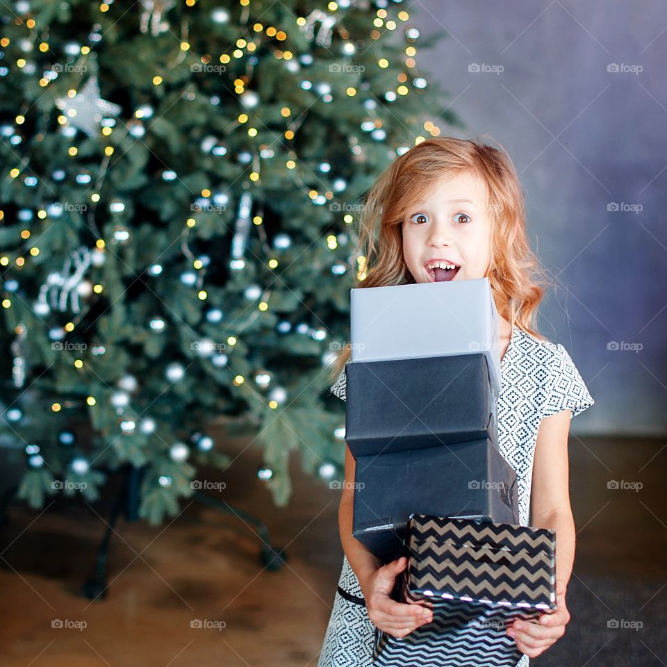 girl holding christmas presents