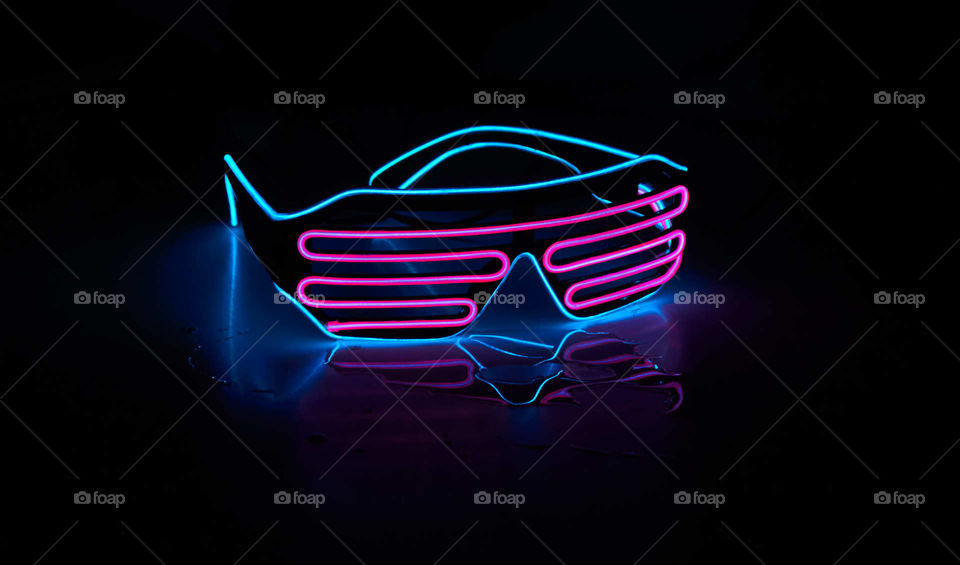 Neon glasses on black background