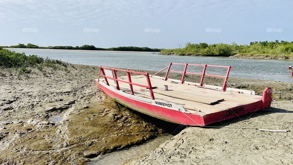 Pink fisher boat on sand 