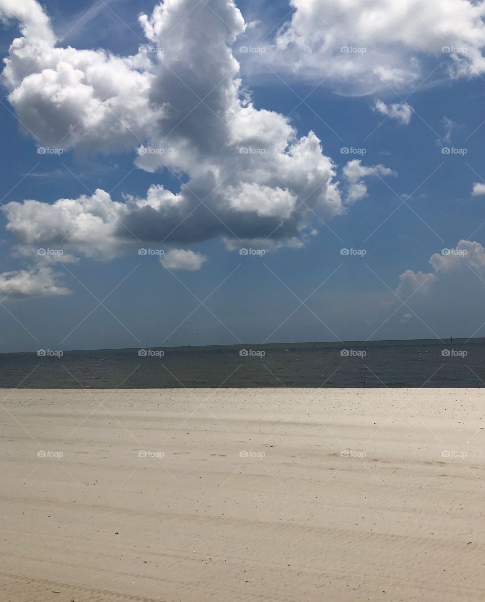 Low hanging clouds over the Gulf in Mississippi, with plenty of sand. 