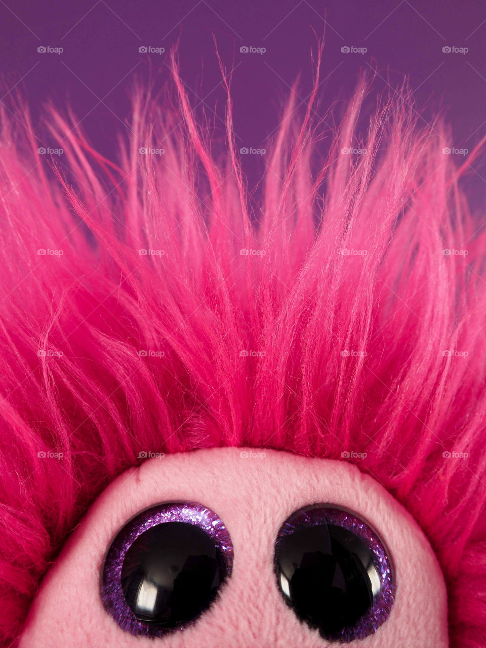 Stuffed toy monster peeking into frame 