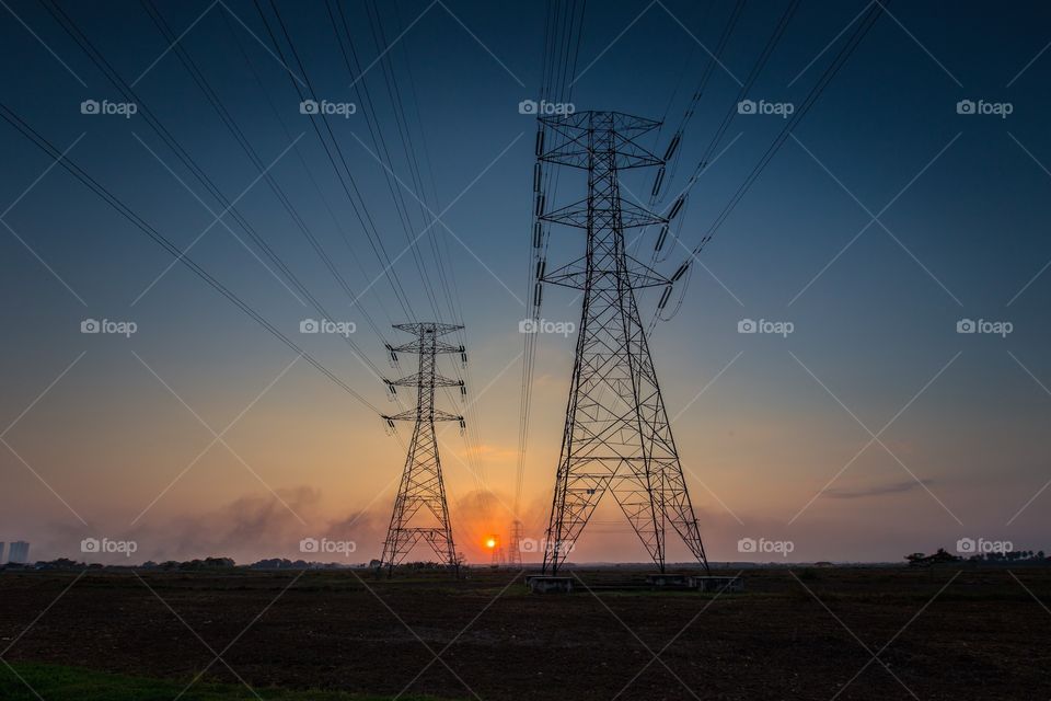 Sunset between two towers. Sunset between two transmission tower power line