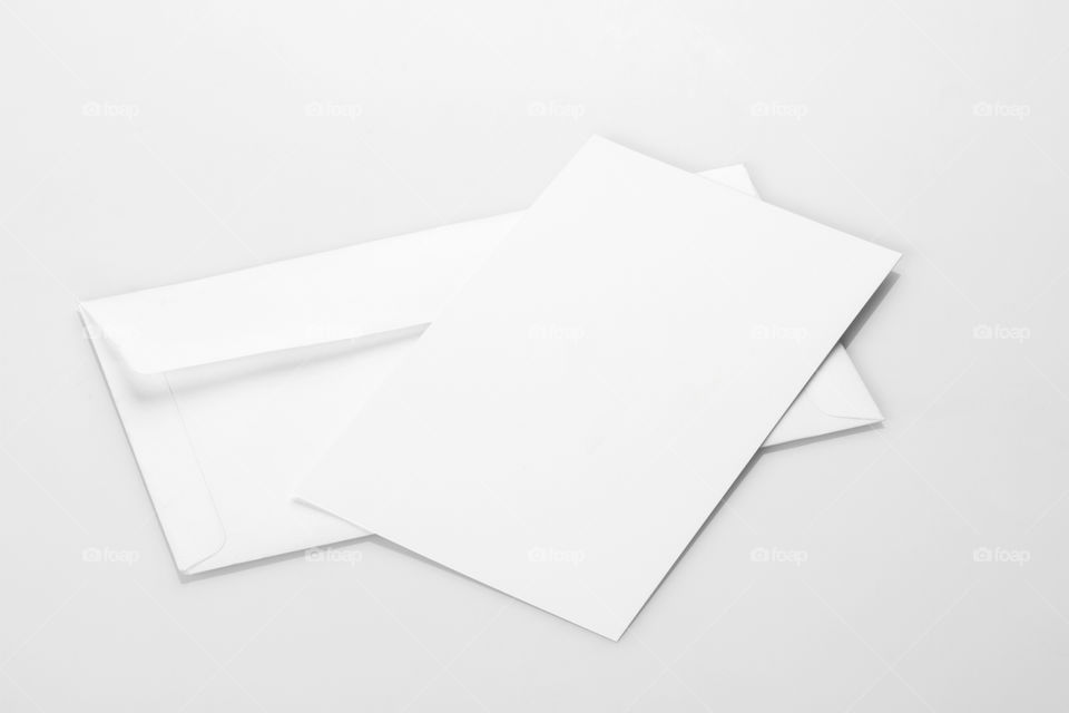 Blank white envelope mockup with an invitation card