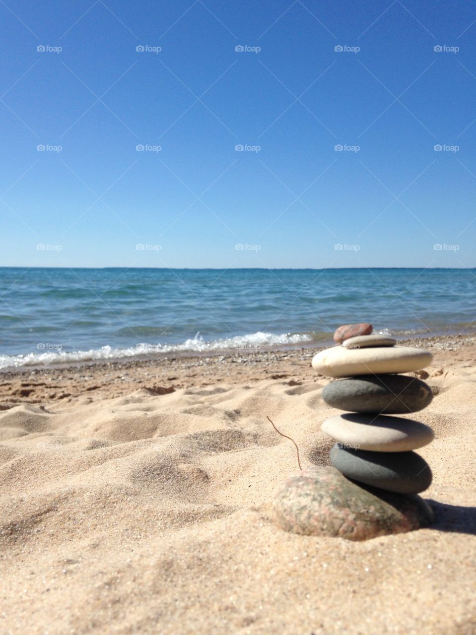 Smooth balanced rocks on the sandy shores of Lake Michigan in Petoskey Michigan 