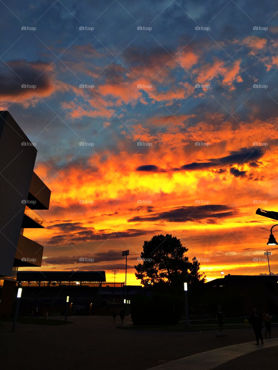This photo captures a fiery sunset on a college campus in Phoenix, Arizona. 