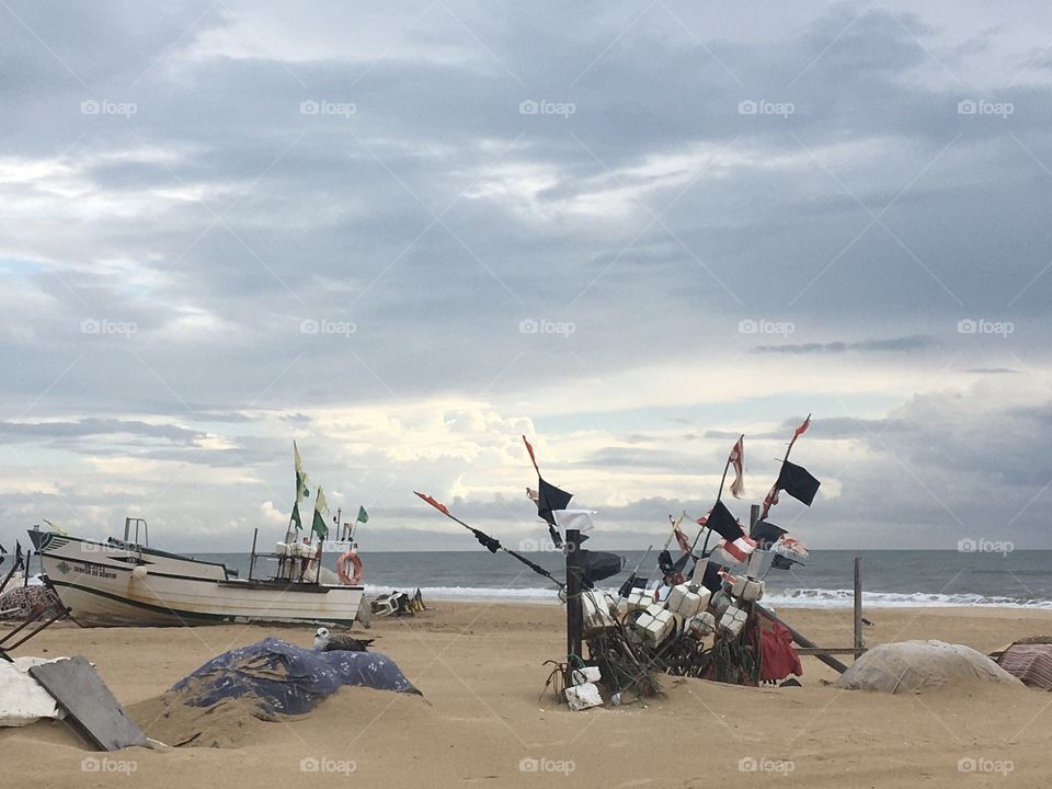 Fishermen’s area on beach with a stormy sky