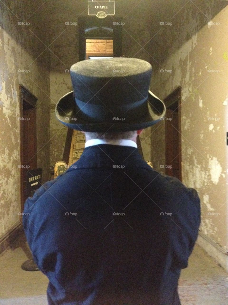 Man in a Victorian Top Hat in a hallway in the Ohio reformatory 