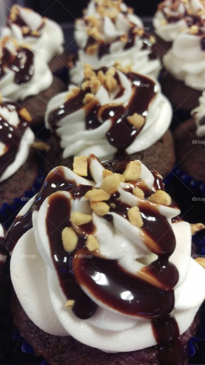 chocolate cupcake with vanilla buttercream icing, peanuts, and chocolate drizzle