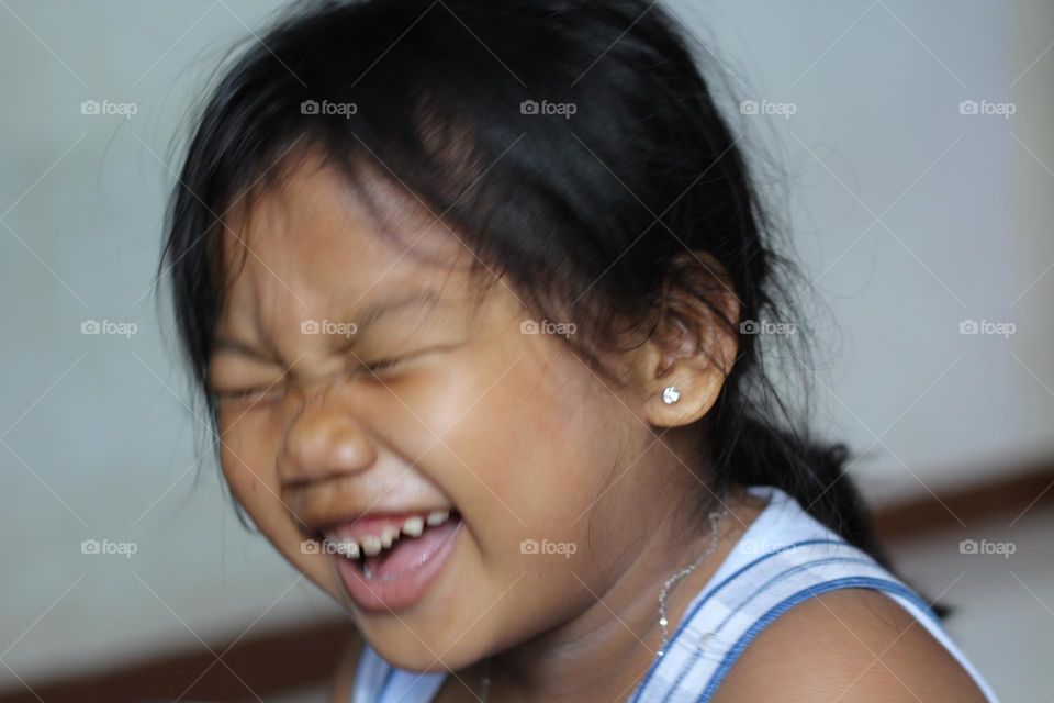 Portrait of little girl laughing.