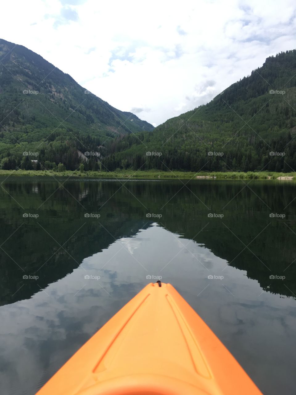 Kayaking on a clear alpine lake in the Rocky Mountains if Colorado. 
