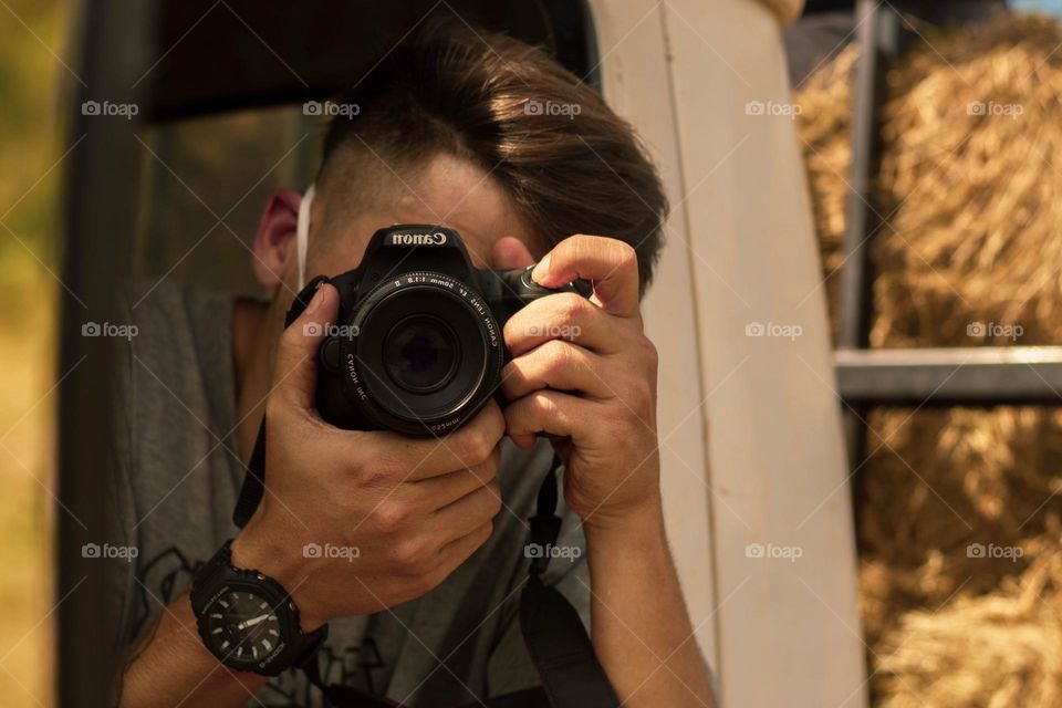 Retrato de garoto tirando foto no reflexo do espelho.