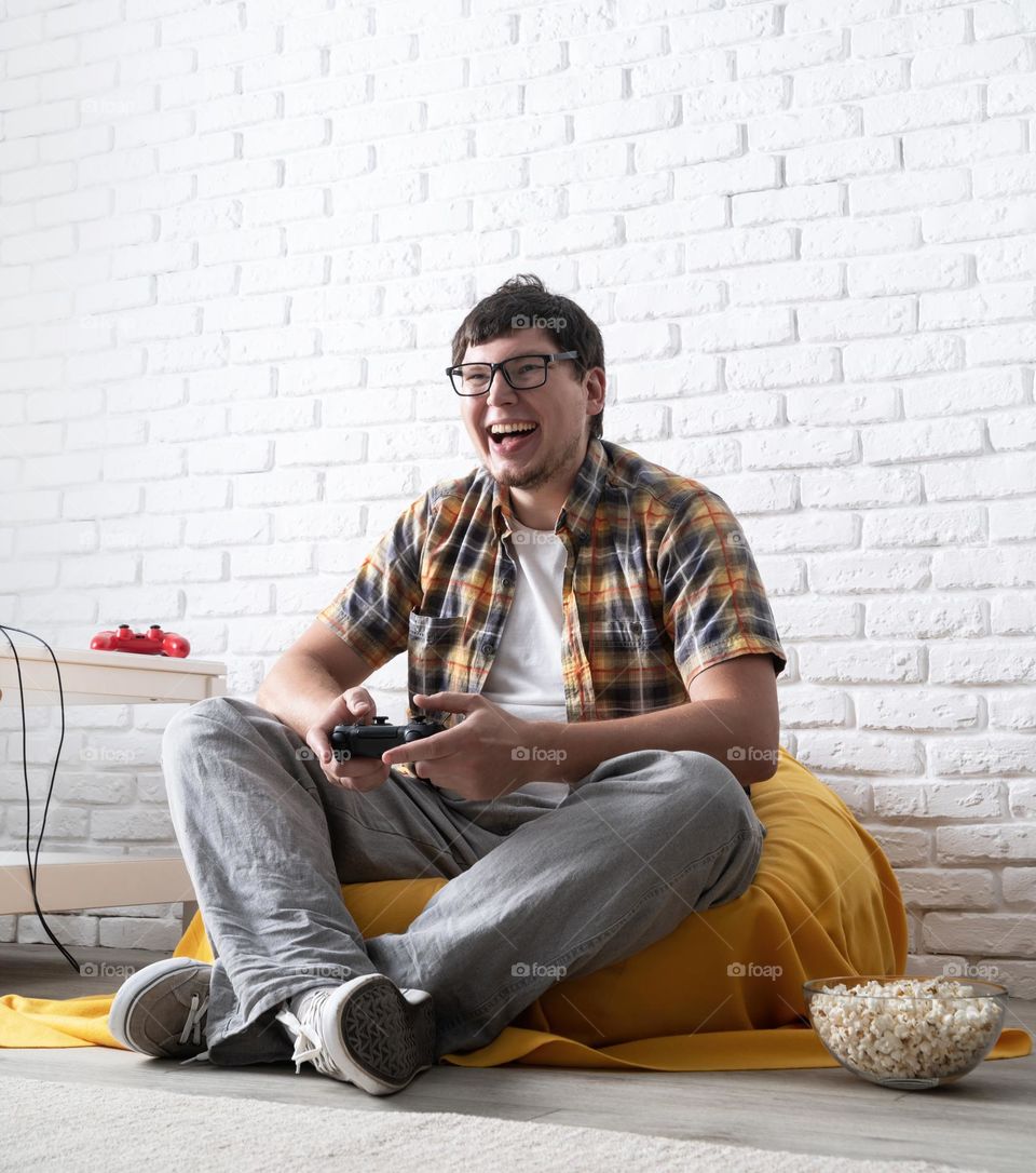 young emotional man playing video games